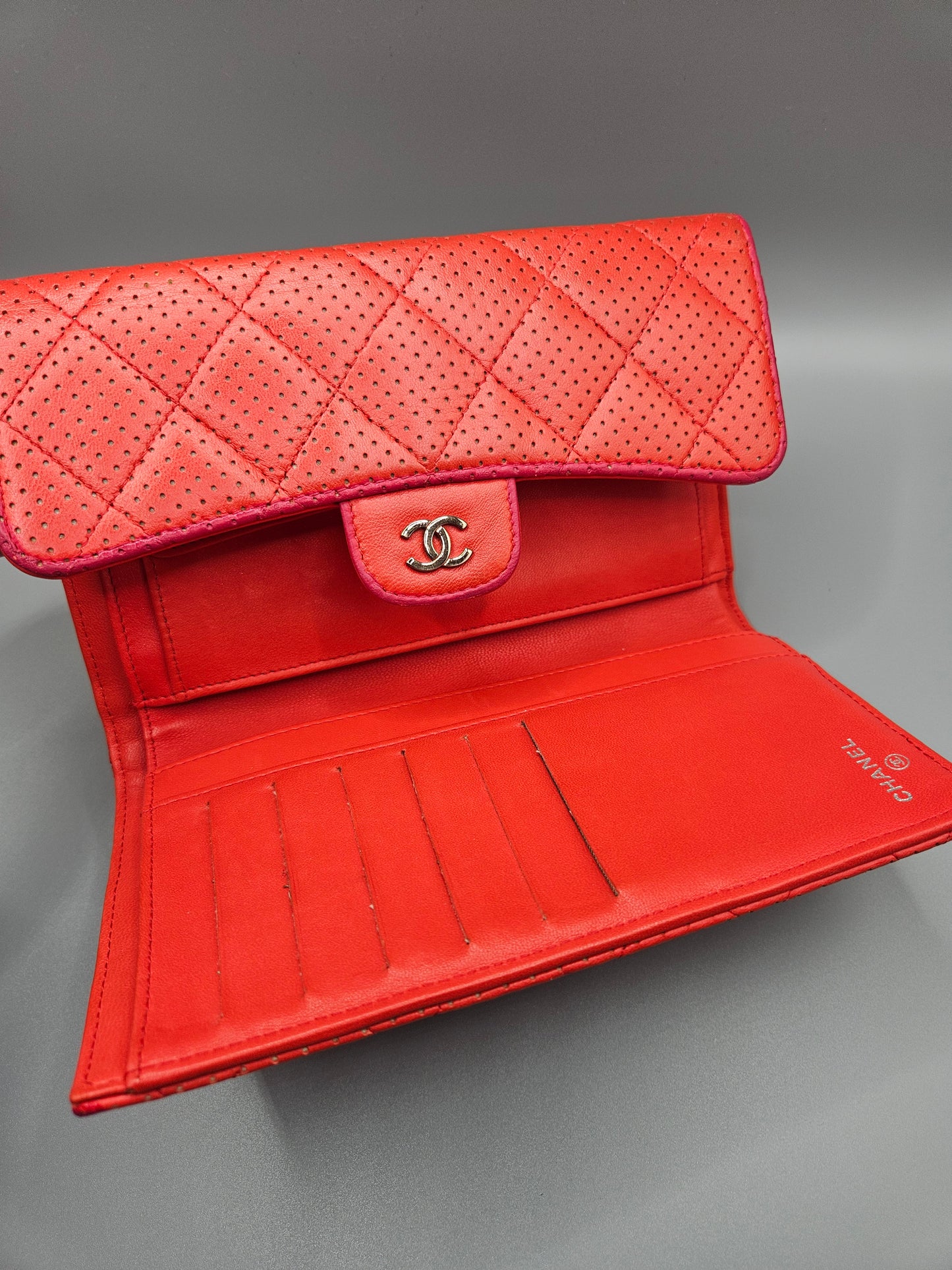 CHANEL Quilted Perforated Leather Wallet in Coral Red